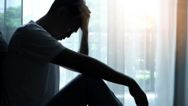 A man sitting with his head in his hands