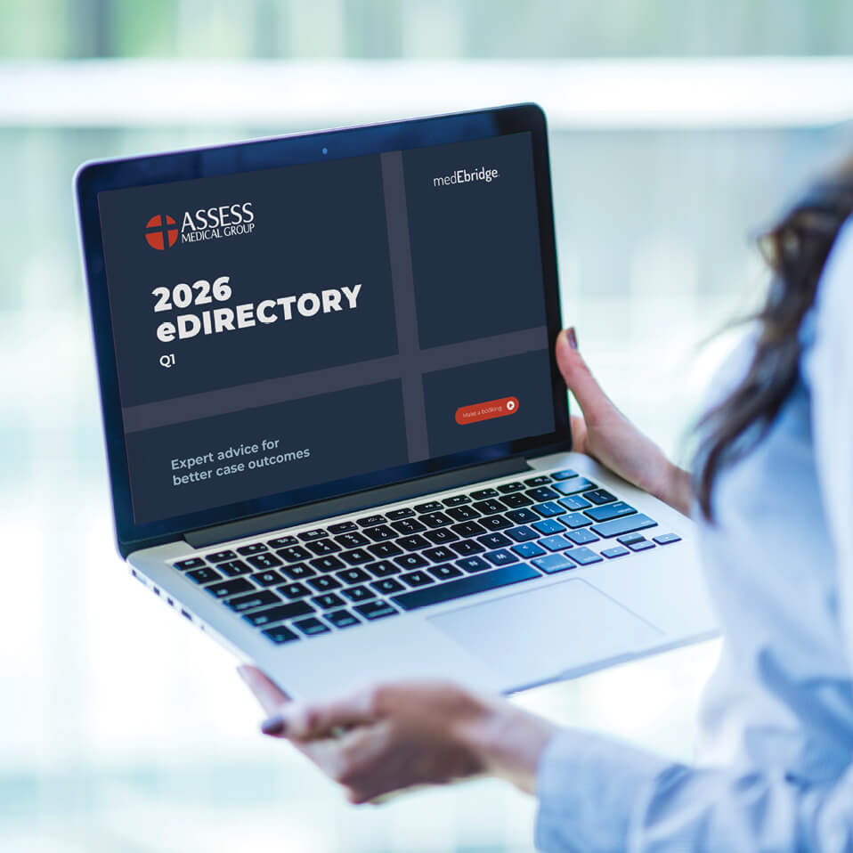 A woman holding a laptop. The 2026 eDirectory is on-screen
